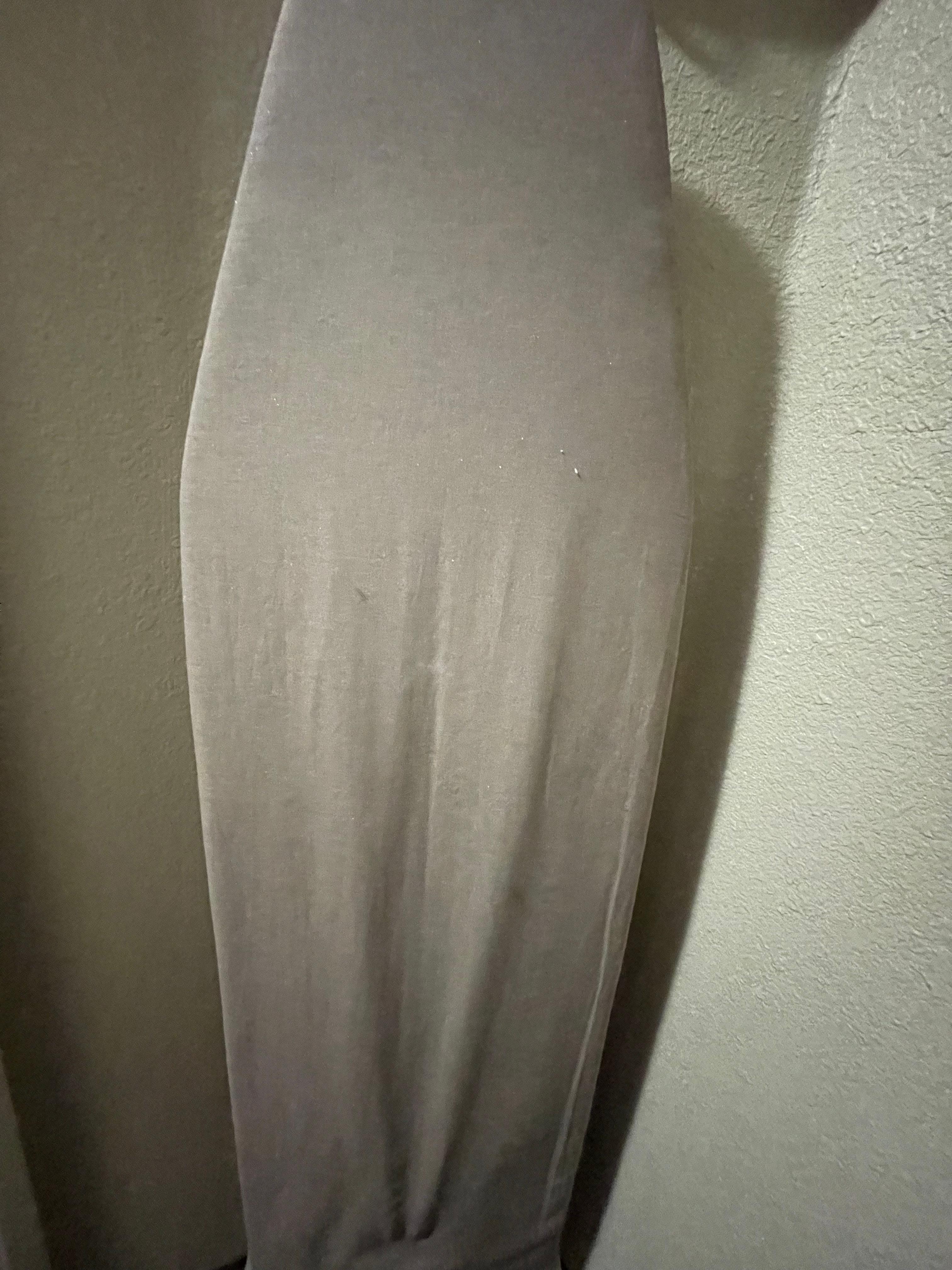 Dirty, stained ironing board.