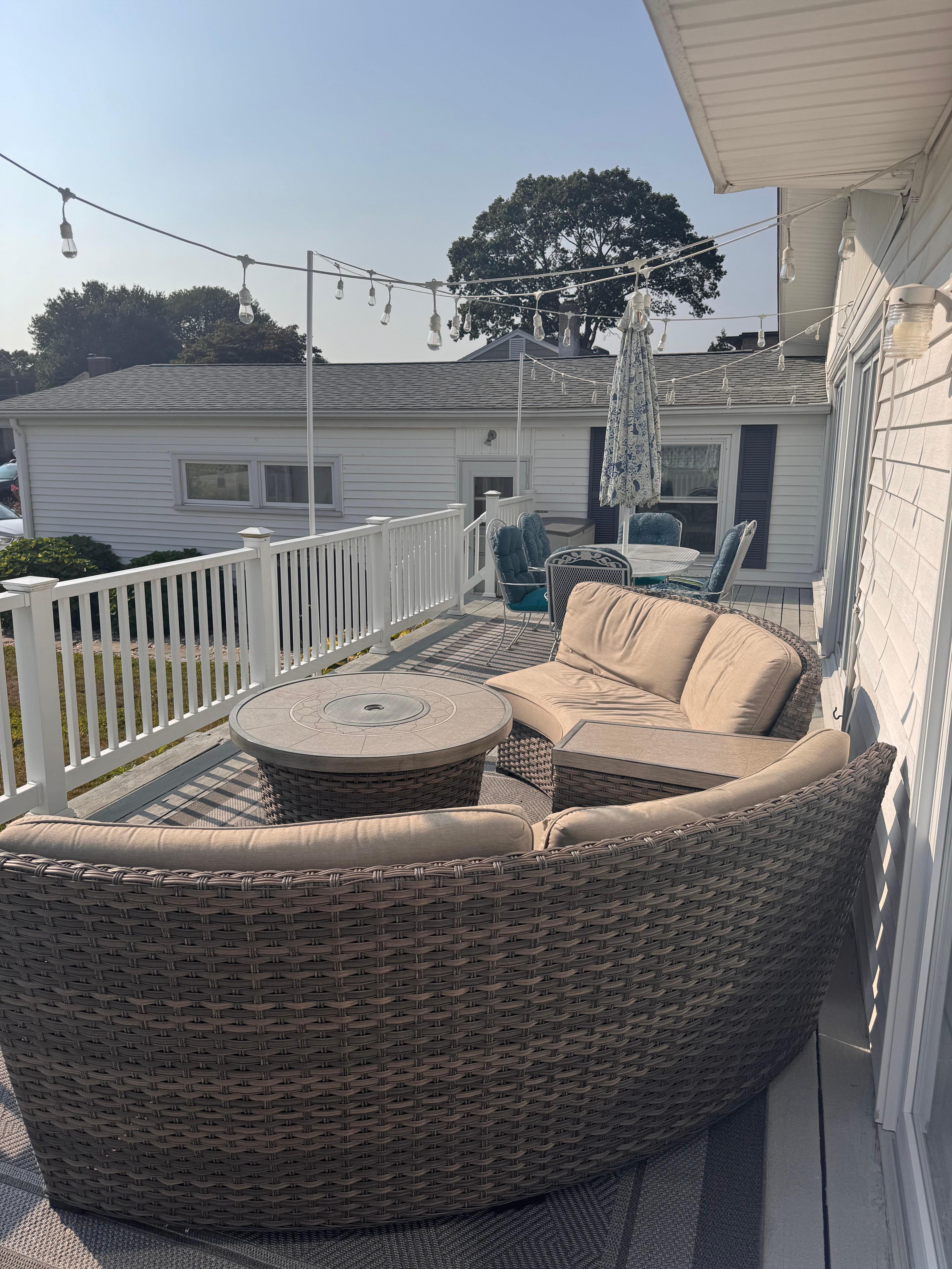 Back deck with table-top fire-pit facing yard with fire-pit and grill