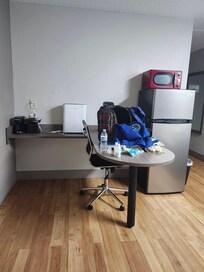 Nice fridge and microwave, basic office area.
