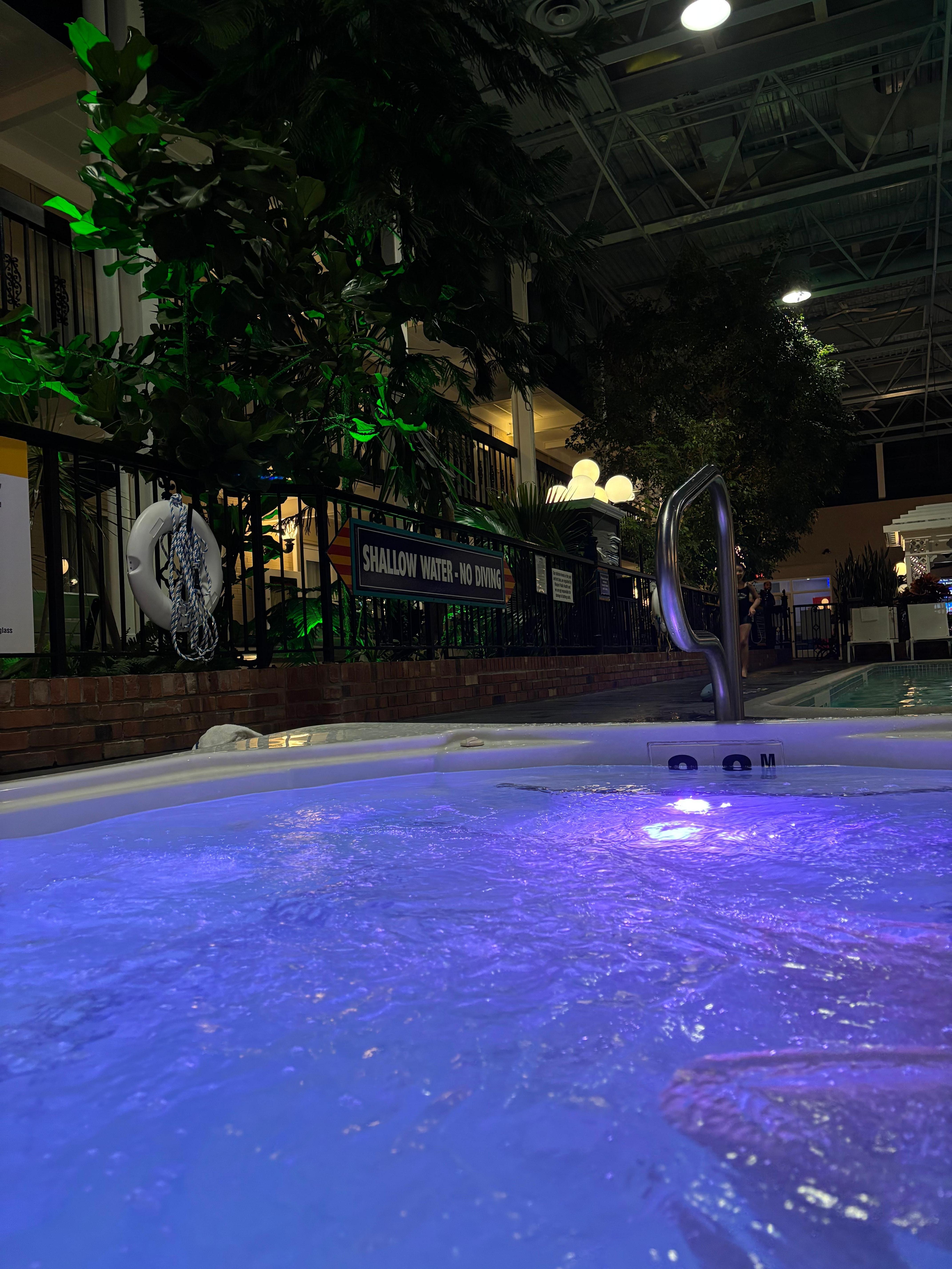 jacuzzi lights up the courtyard during evening hours 