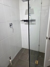Great shower,accessible with no step in. Massive vanity.
