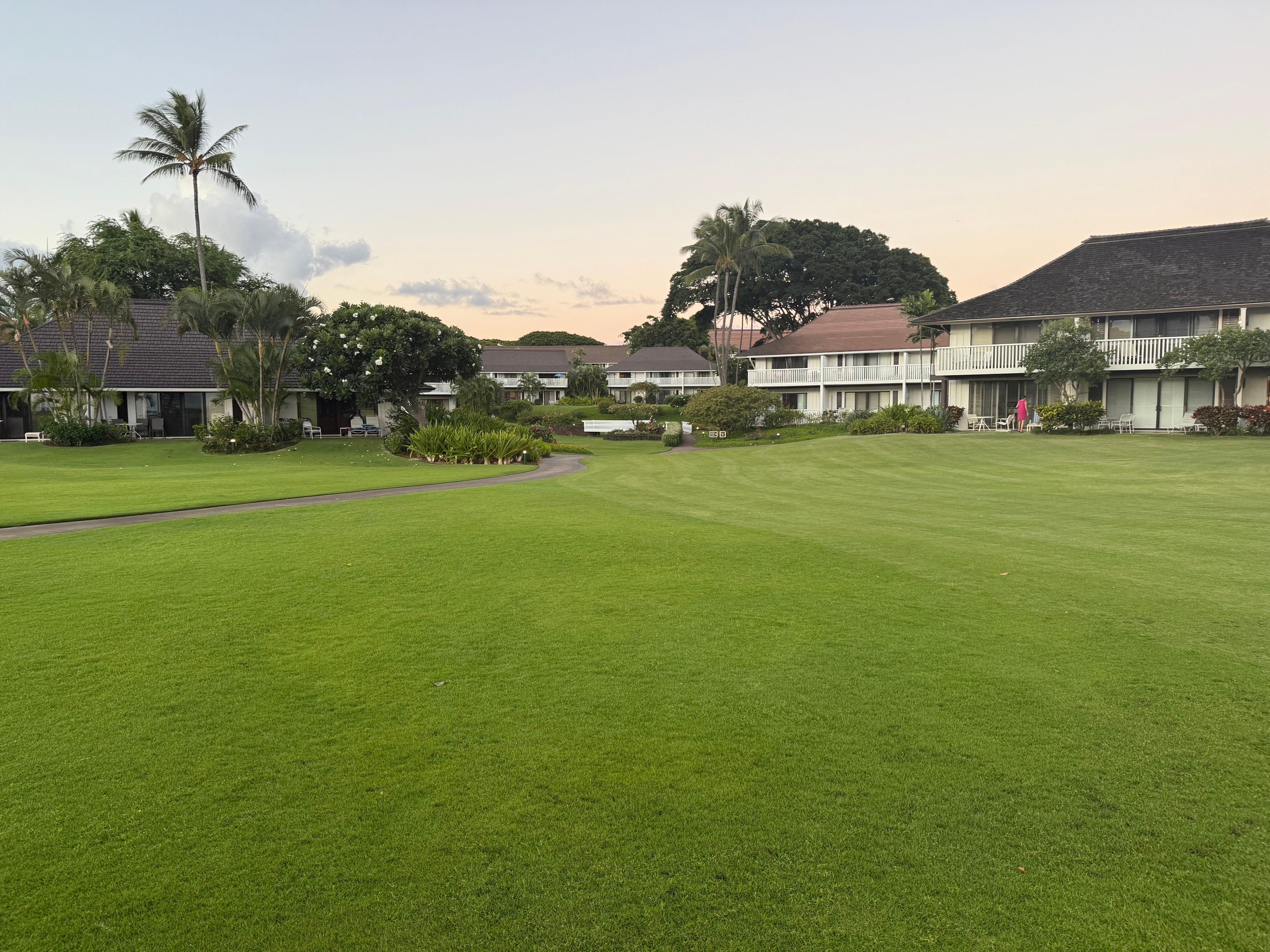 Grassy area leading from condos to beaxh