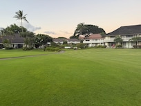 Grassy area leading from condos to beaxh