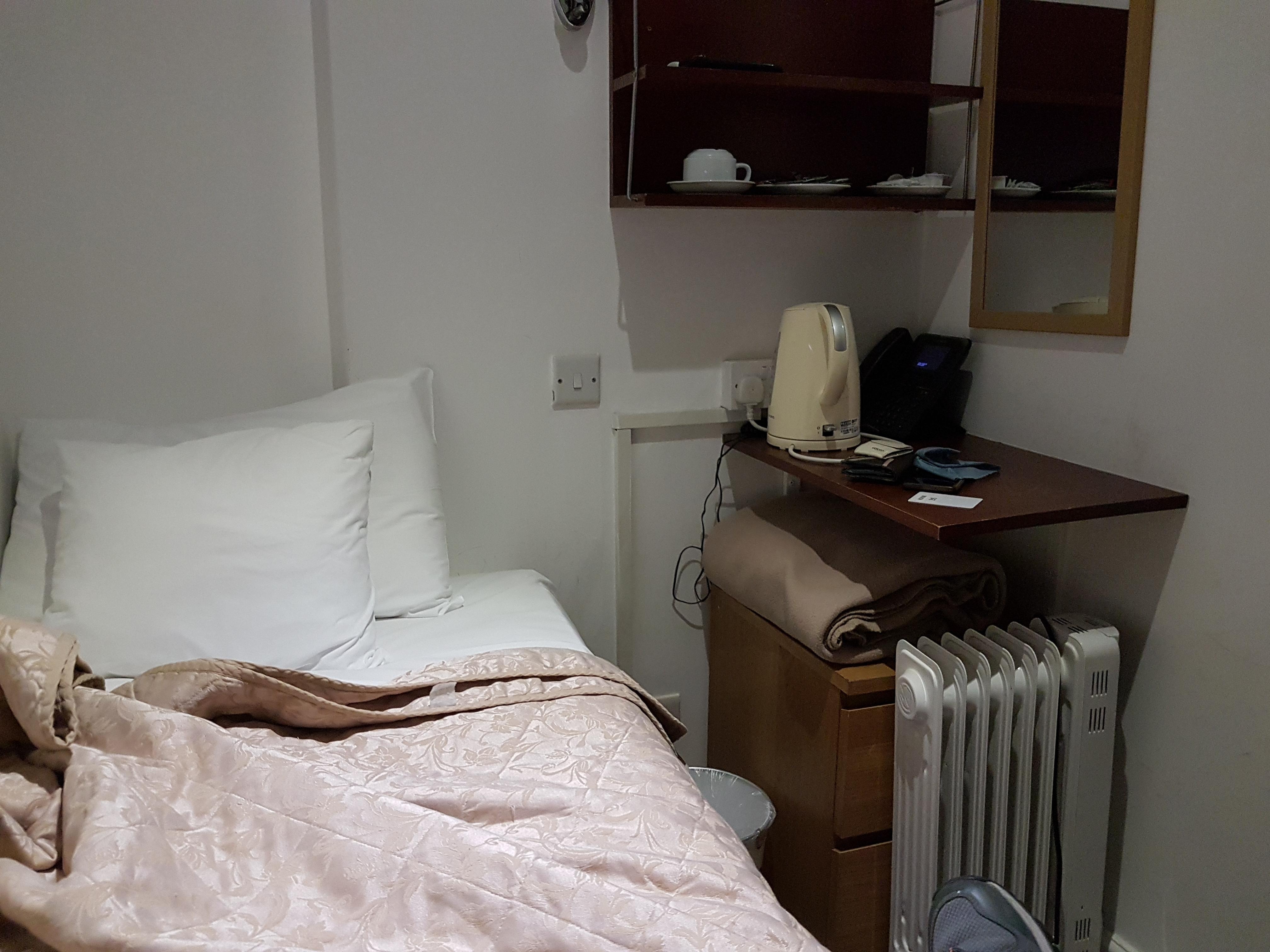 There isn't even room to fall out of bed on the one side not up against a wall