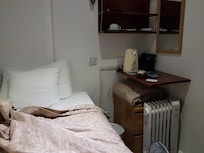 There isn't even room to fall out of bed on the one side not up against a wall