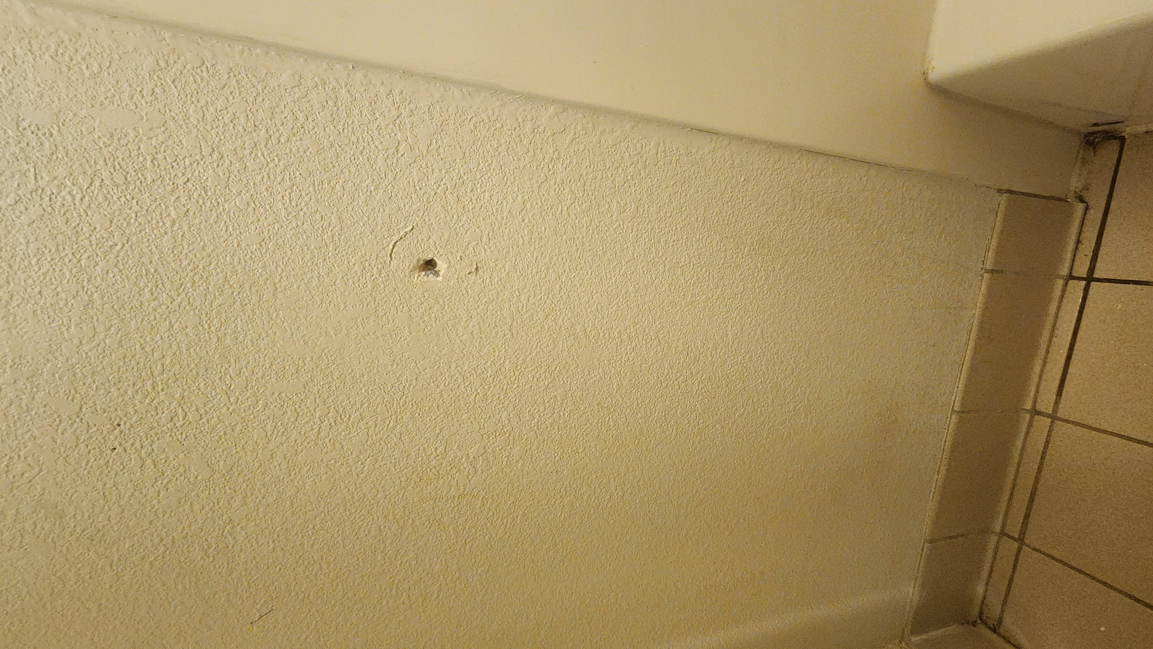 Hole in the wall in the bathroom