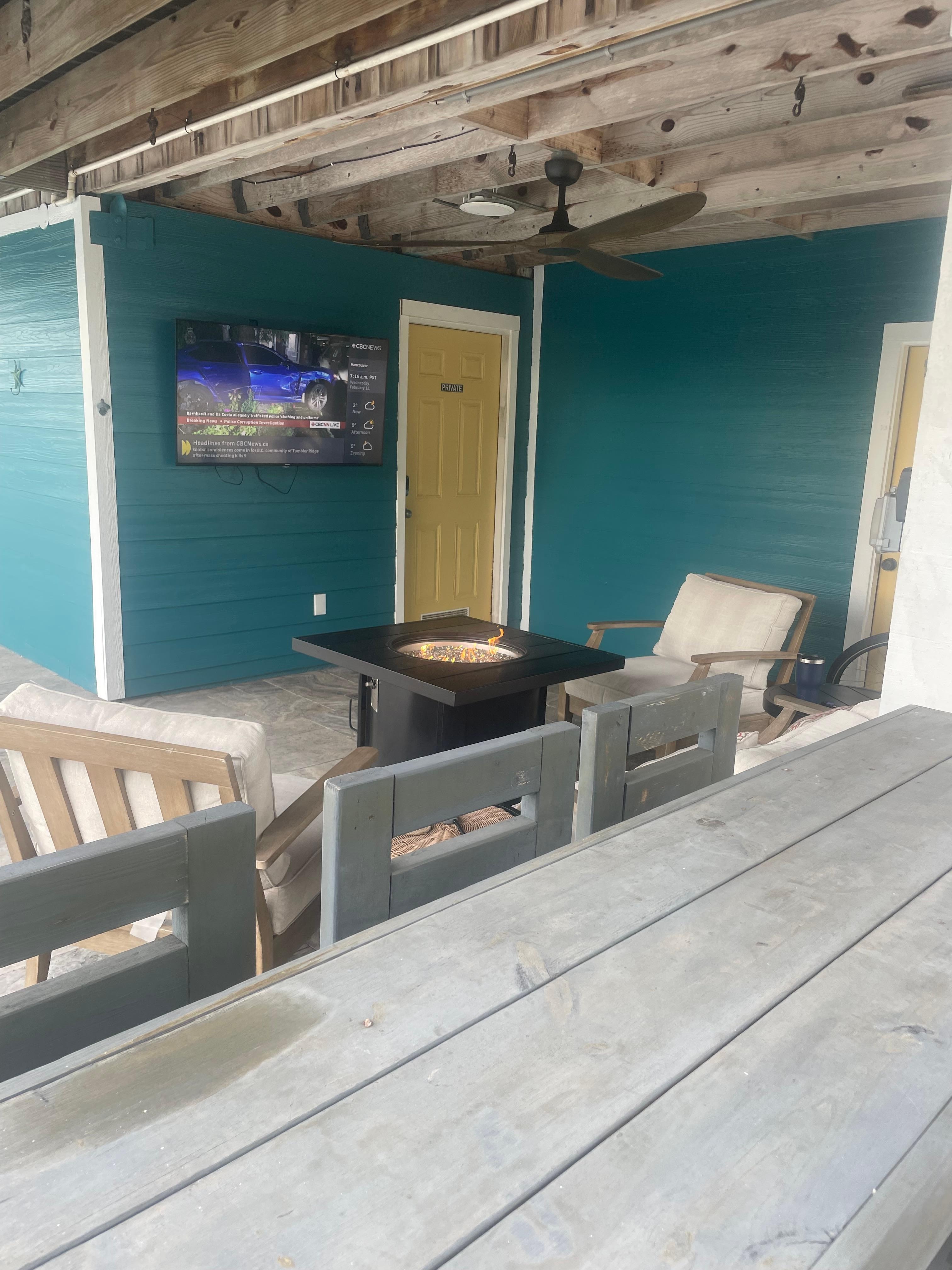 Outdoor fire pit, bar and television made for a nice entertainment area