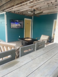 Outdoor fire pit, bar and television made for a nice entertainment area