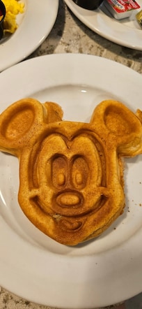 Breakfast buffet offers Mickey shaped items.