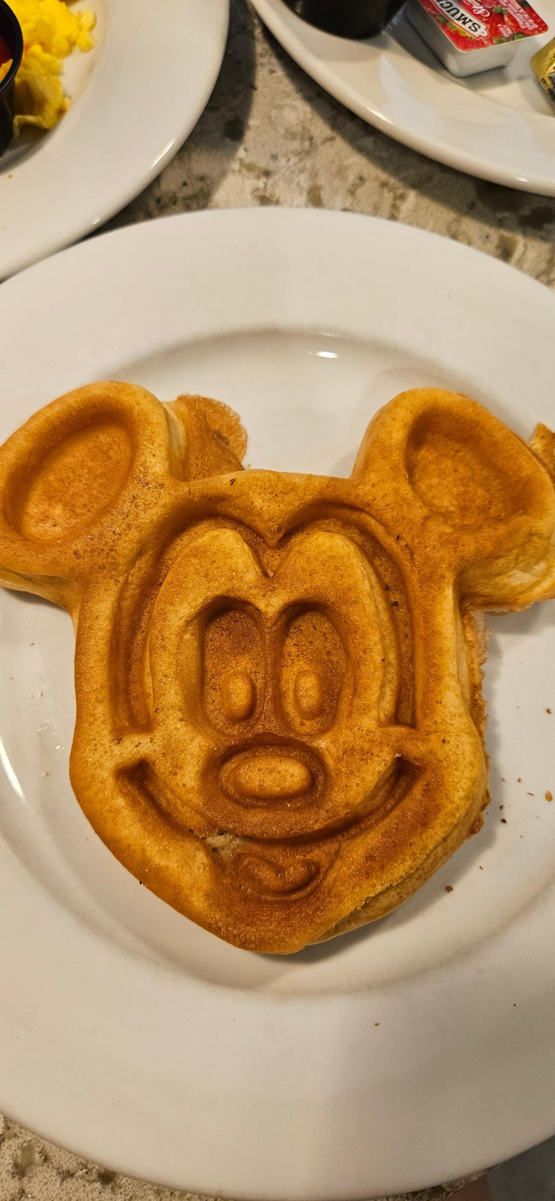 Breakfast buffet offers Mickey shaped items. 