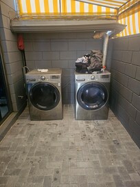 Someone else's laundry found in dryer and lint trap full and no laundry detergent available to use.