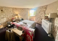 My gorgeous room w view of the Pyrenees and fortifications containing a rugby field.