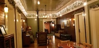 Common area, fireplace, fridge, sitting area, table.