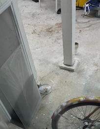 View out of kitchen window, including the screen sitting on the ground that should be on the window.