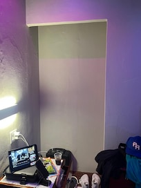 Closet with no door or rod to hang clothes in.