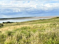 View from across the road Bamburgh castle in distance
