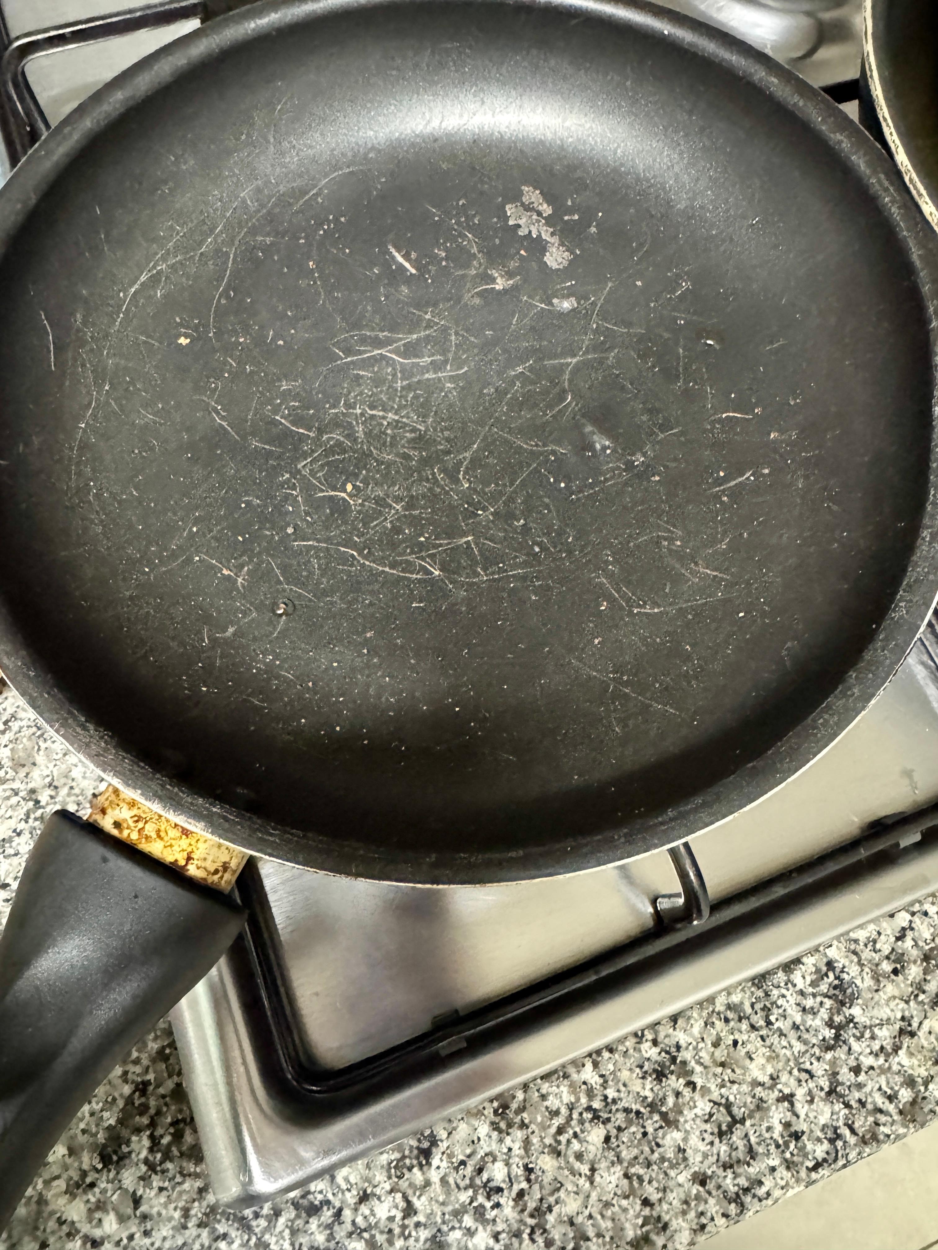 Loose handle, scratched, dirty. All the nonstick looked like this