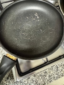Loose handle, scratched, dirty. All the nonstick looked like this
