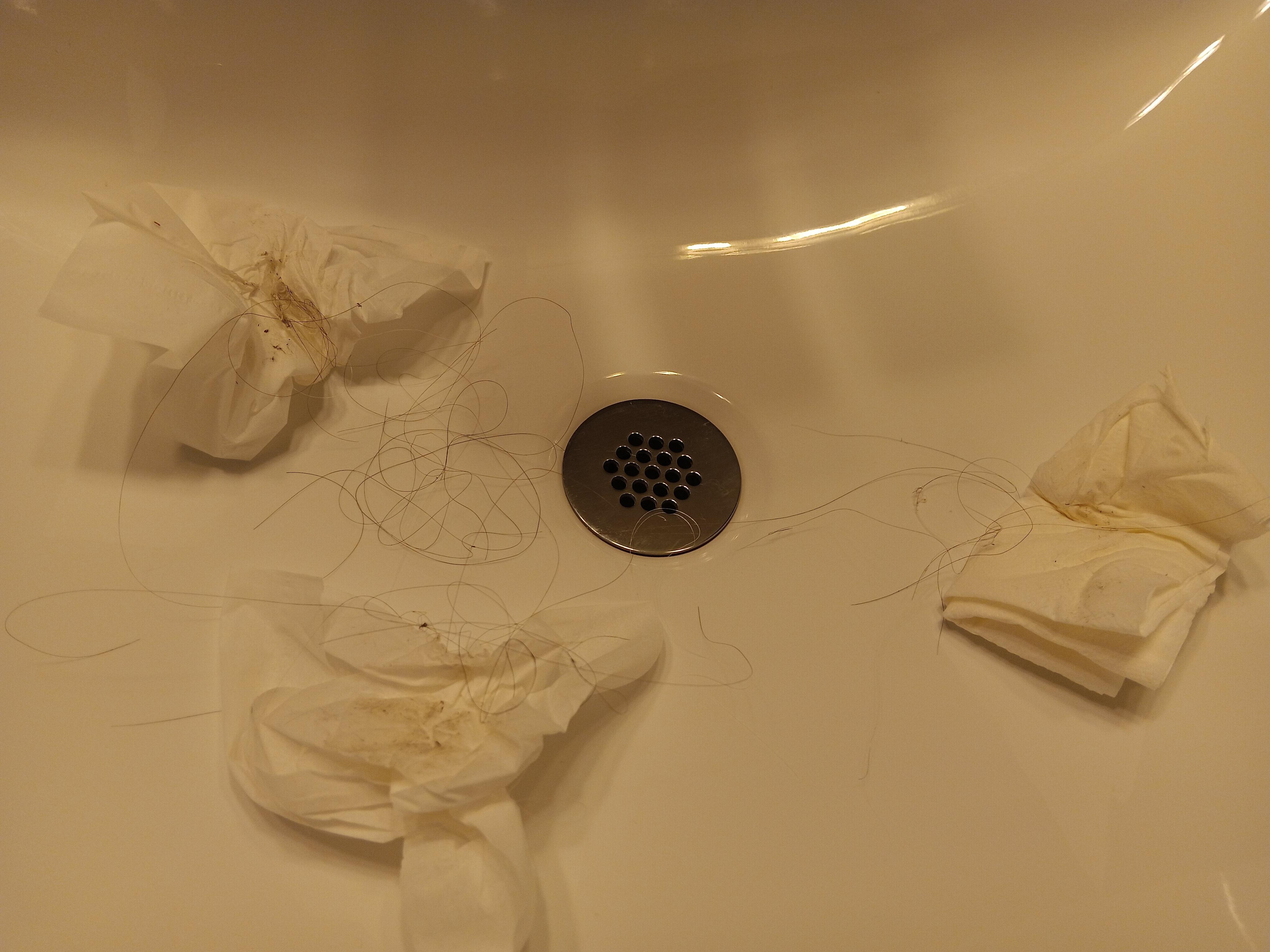 Filthy bathroom floor with long hair 