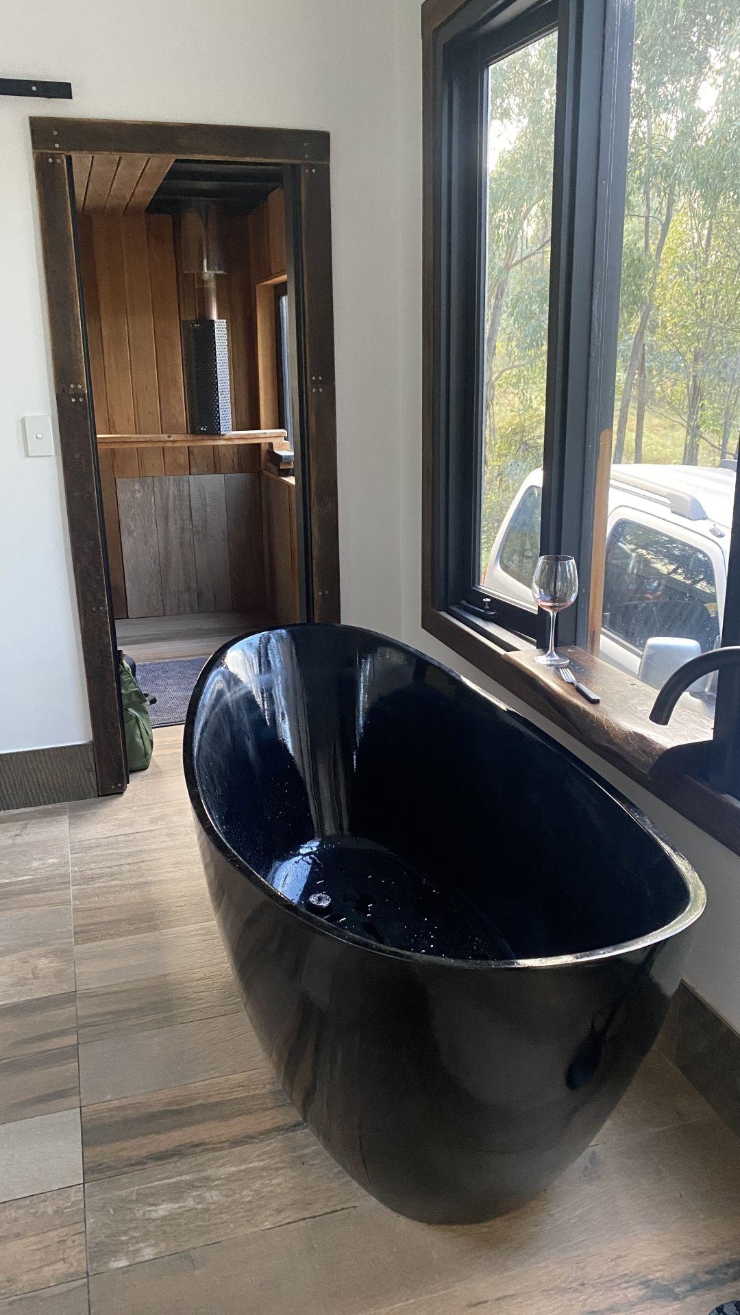 Big bathtub, and sauna being built behind it.