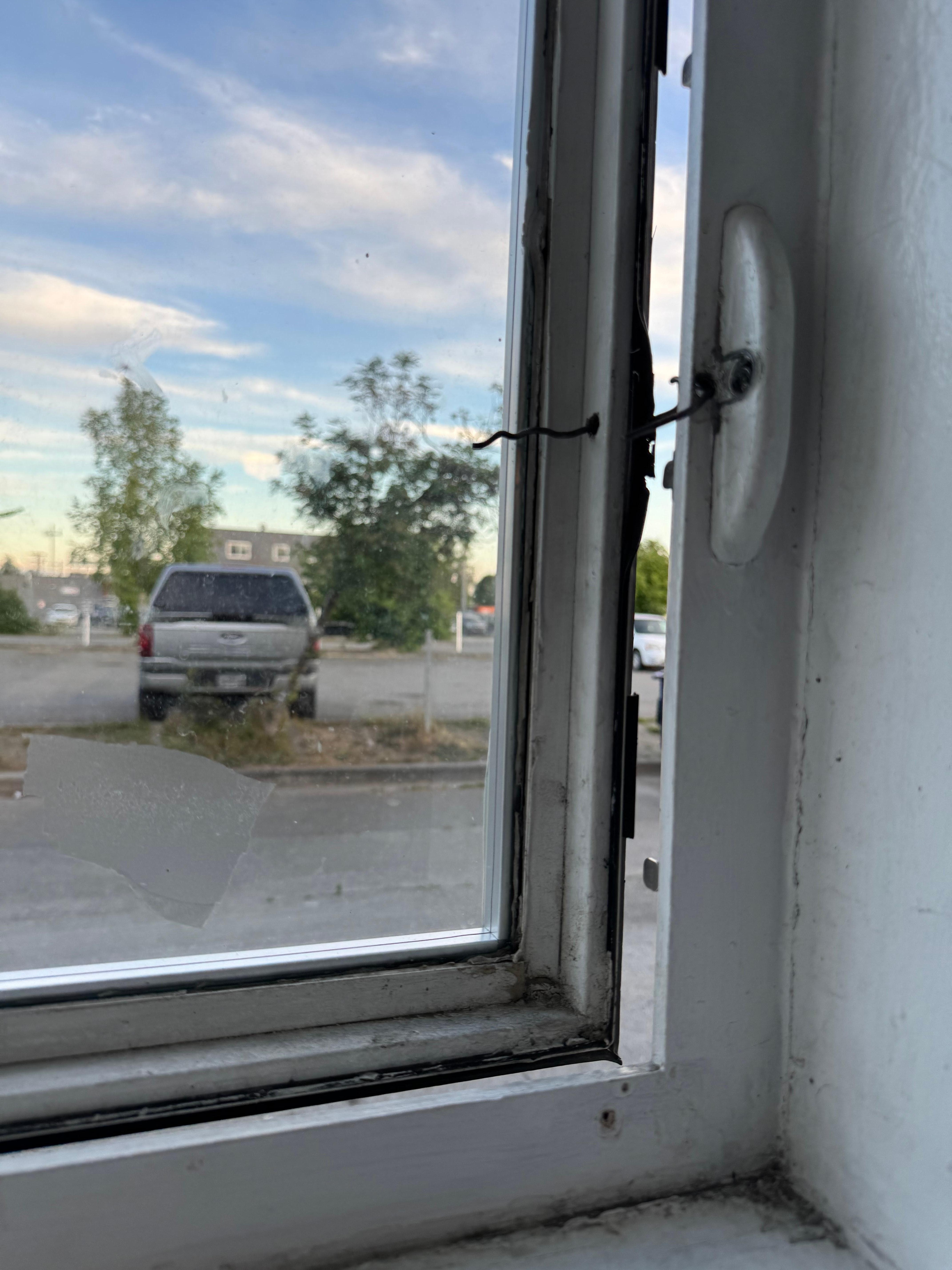 Ground floor, exterior window won’t close. 
Semi-closed with a wire. 
