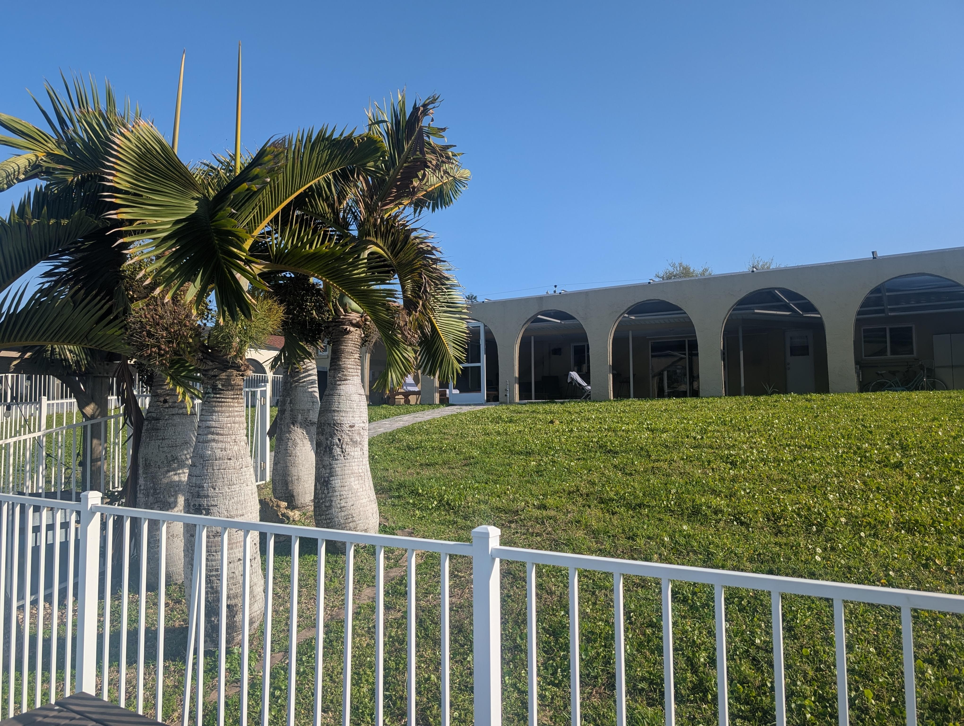 View of the yard and pool from the dock. 