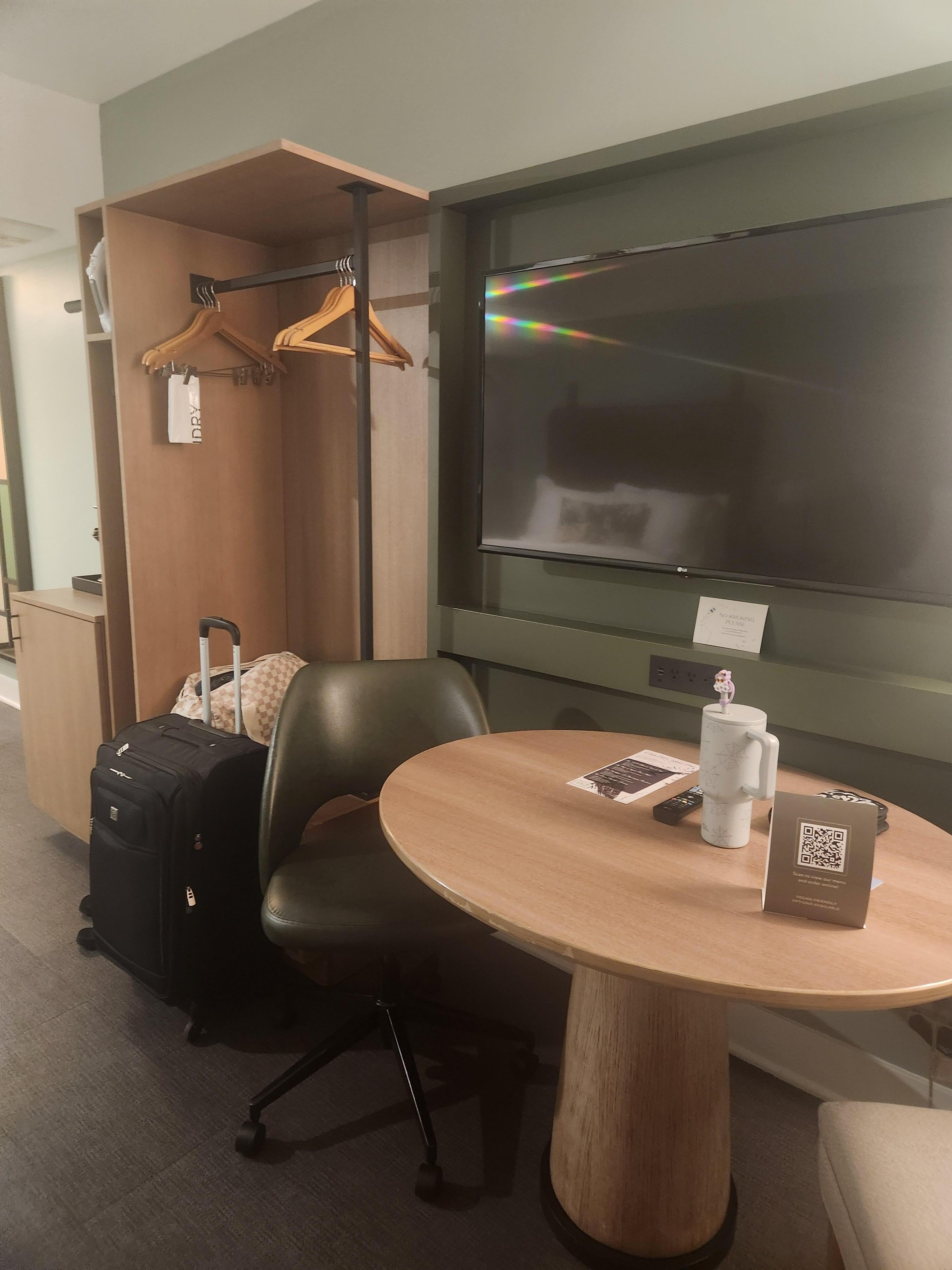 Large TV, table with 2 chairs, room for luggage, coffee/tea maker with K- cups, and a mini fridge. 