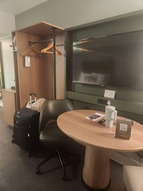 Large TV, table with 2 chairs, room for luggage, coffee/tea maker with K- cups, and a mini fridge.