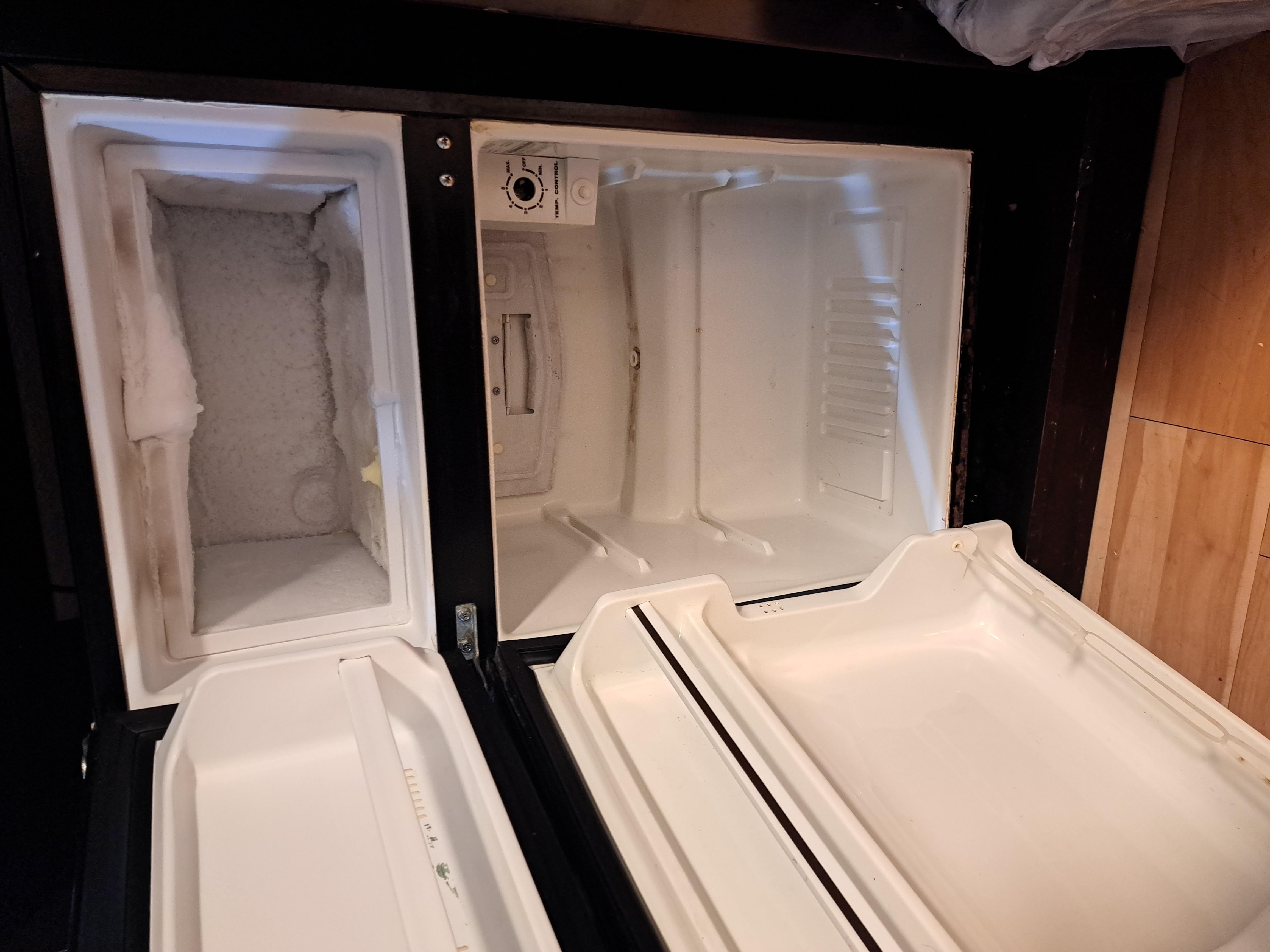 Refrigerator missing shelves. Freezer needs defrosting.