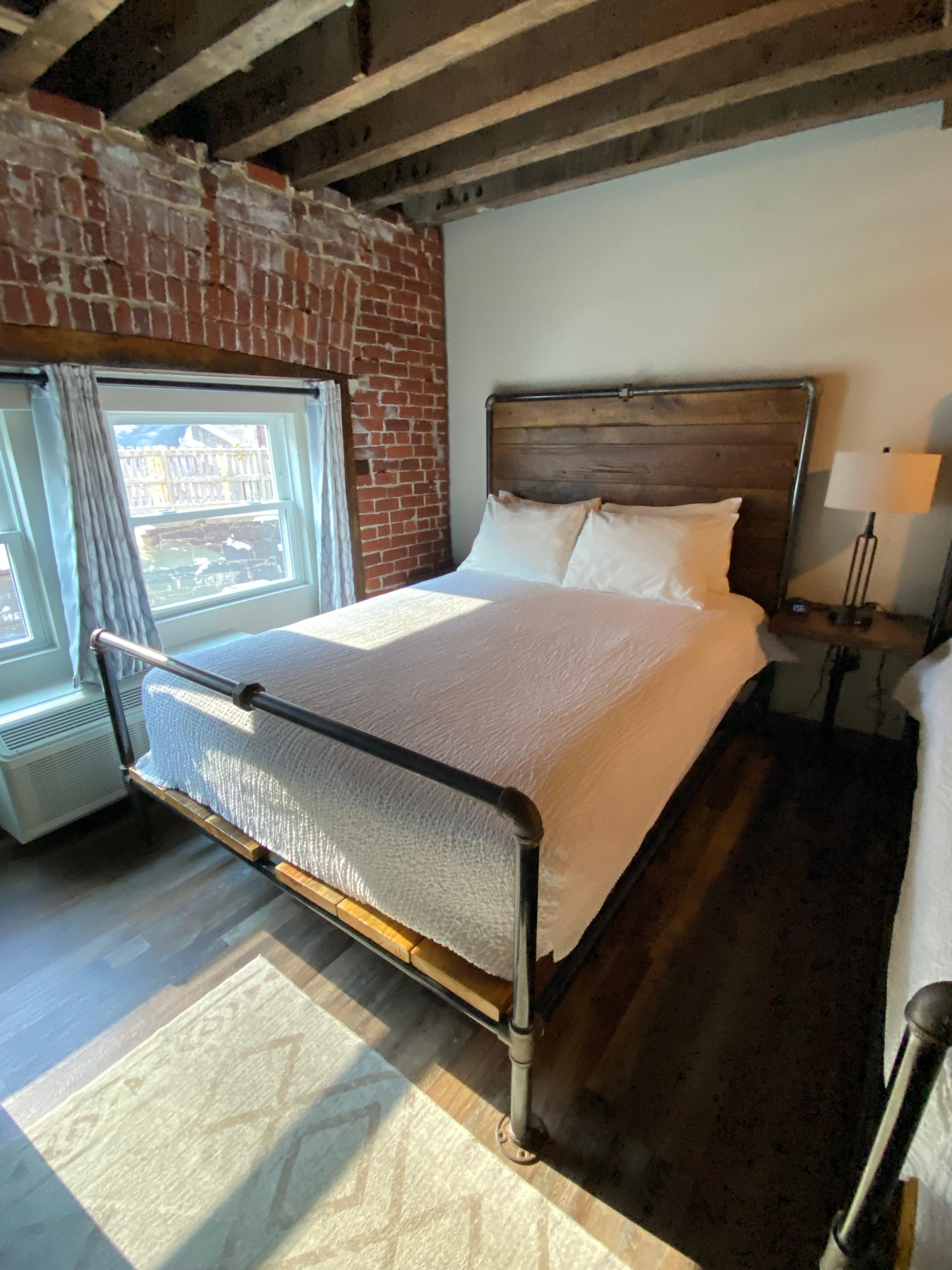 Double guest room with bed frames handmade by owner Duke