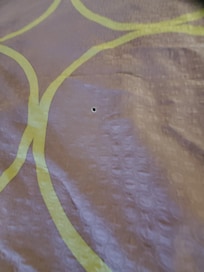 Cigar burns in bedspread