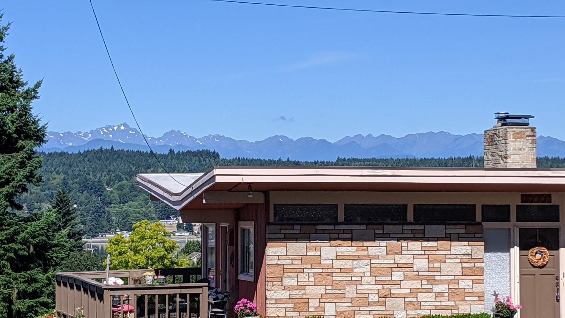 Mountain and water views over house rooftops