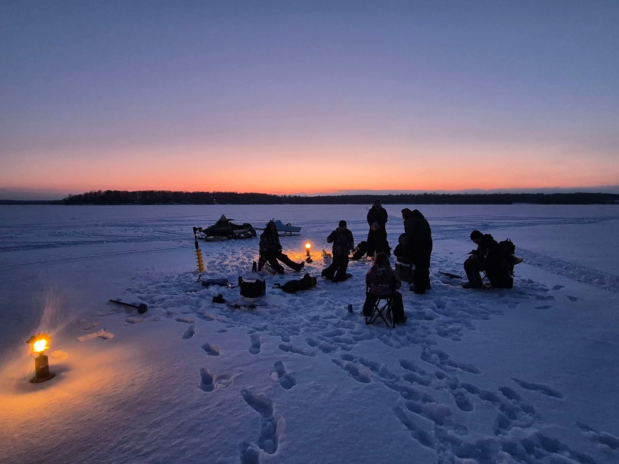 Ice fishing out in front near the cabin