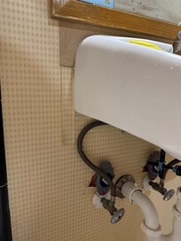 Perfect plumbing and it matches the tilted sink and missing wallpaper.