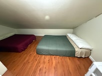 3rd bedroom is a CLOSET WITH 2 MATTRESSES ON THE FLOOR AND A PULL STRING LIGHT