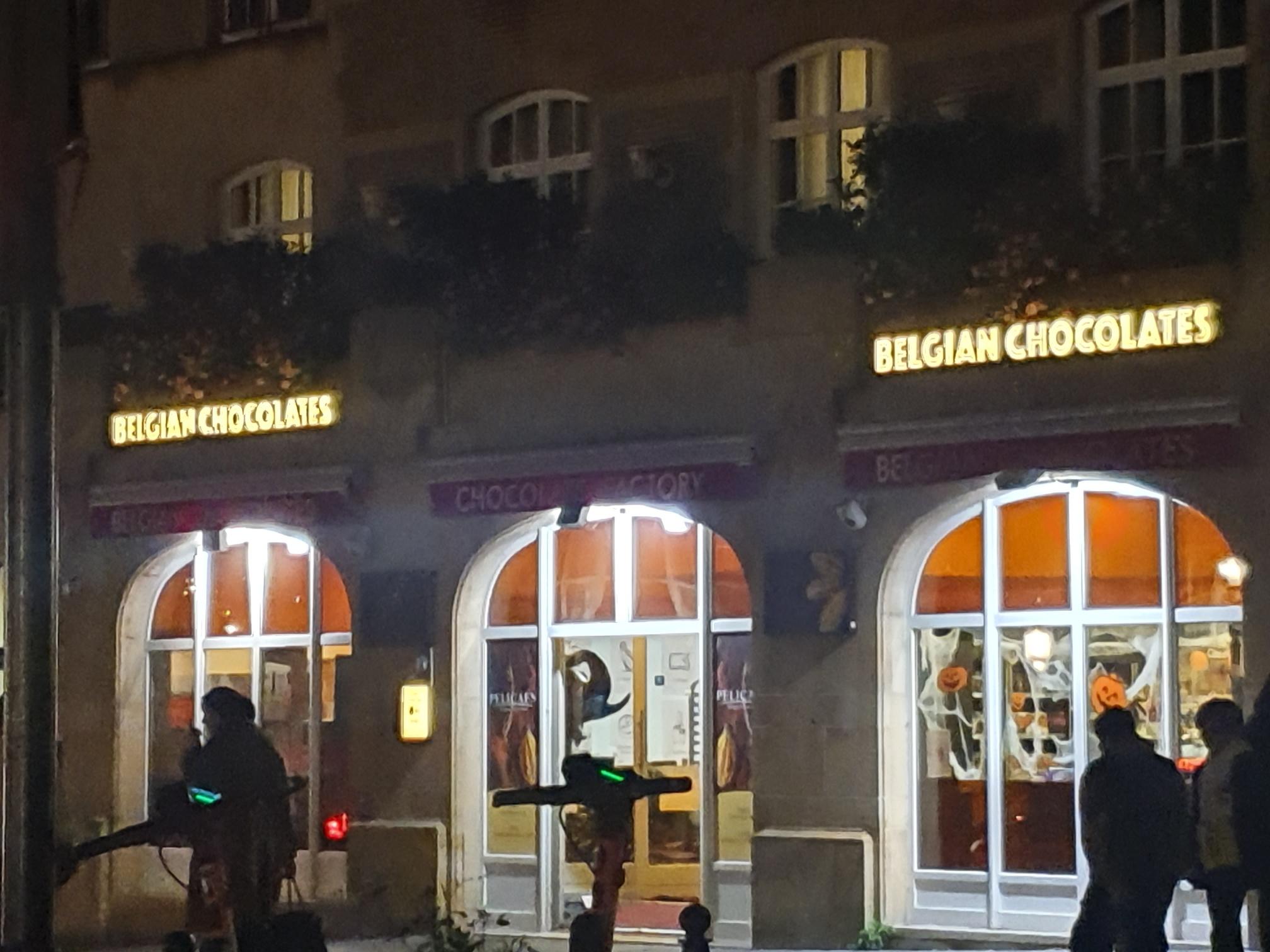 chocolate shop at night next to hotel