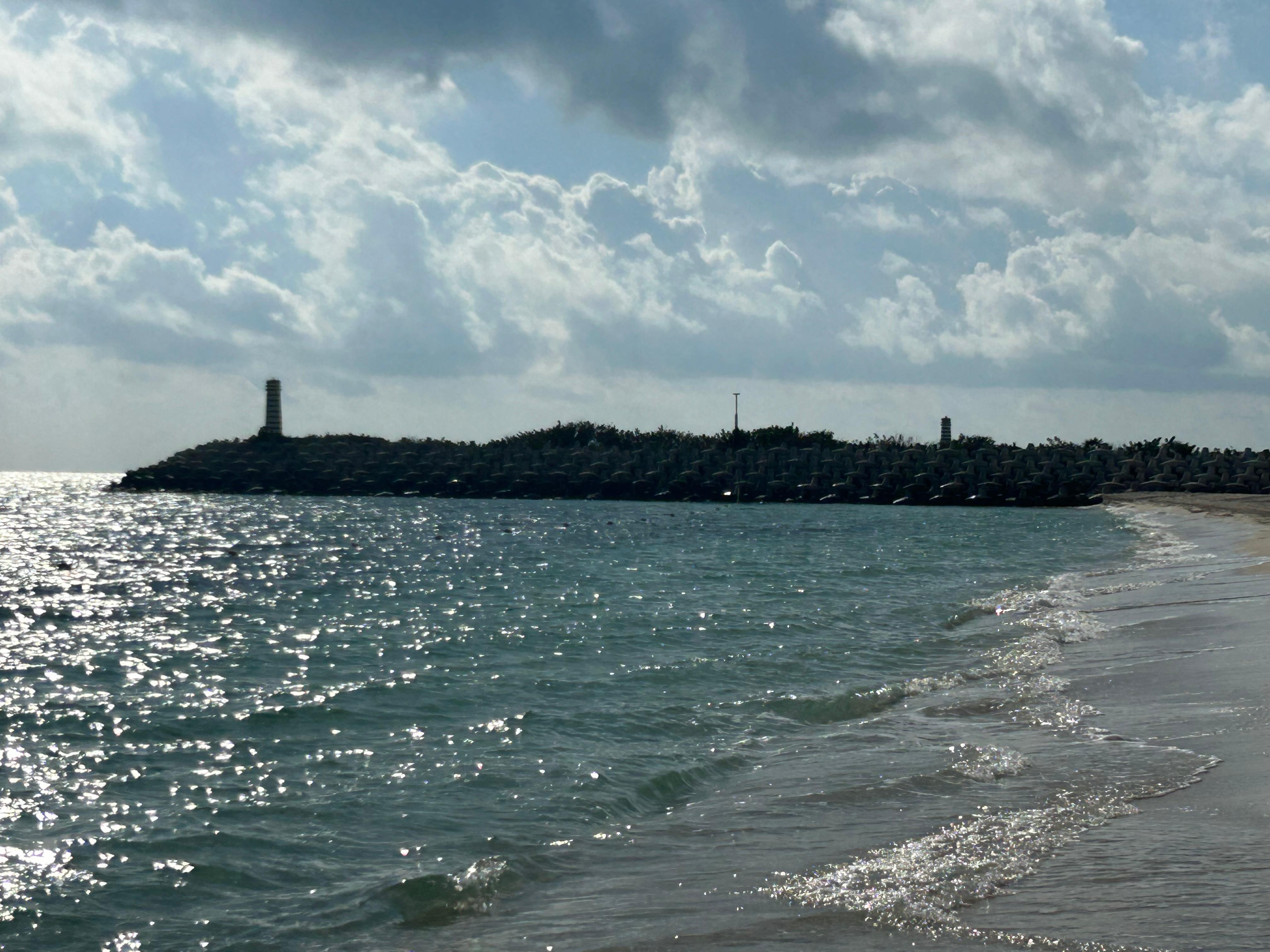 Point with lighthouse seen from the beach. 