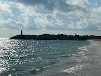 Point with lighthouse seen from the beach.