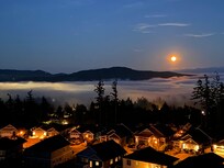 View from the patio of the full “buck moon” reflecting off the fog that rolled over the inlet