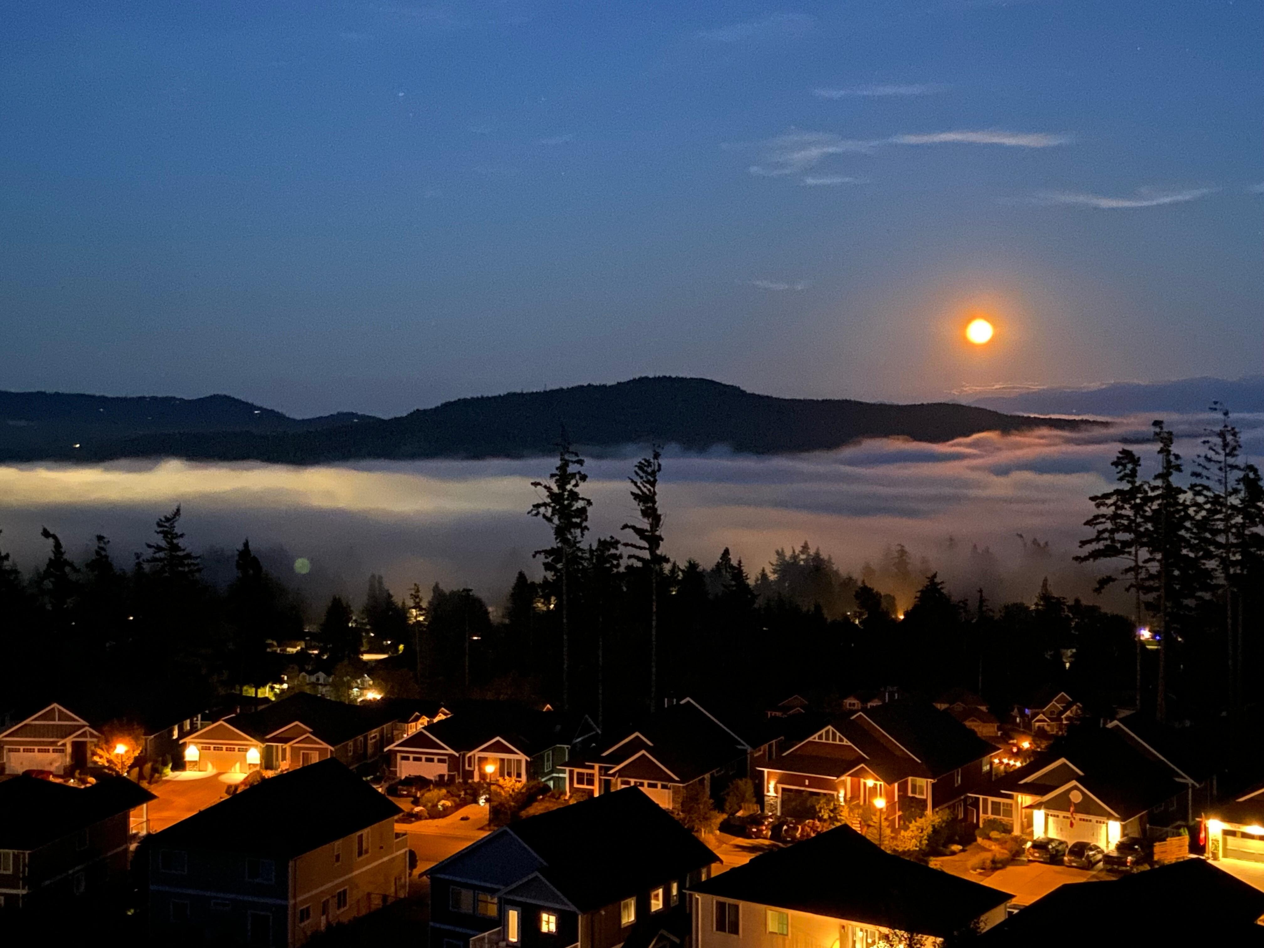 View from the patio of the full “buck moon” reflecting off the fog that rolled over the inlet