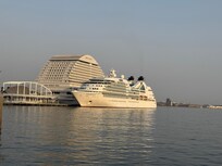 Hotel behind cruise boat