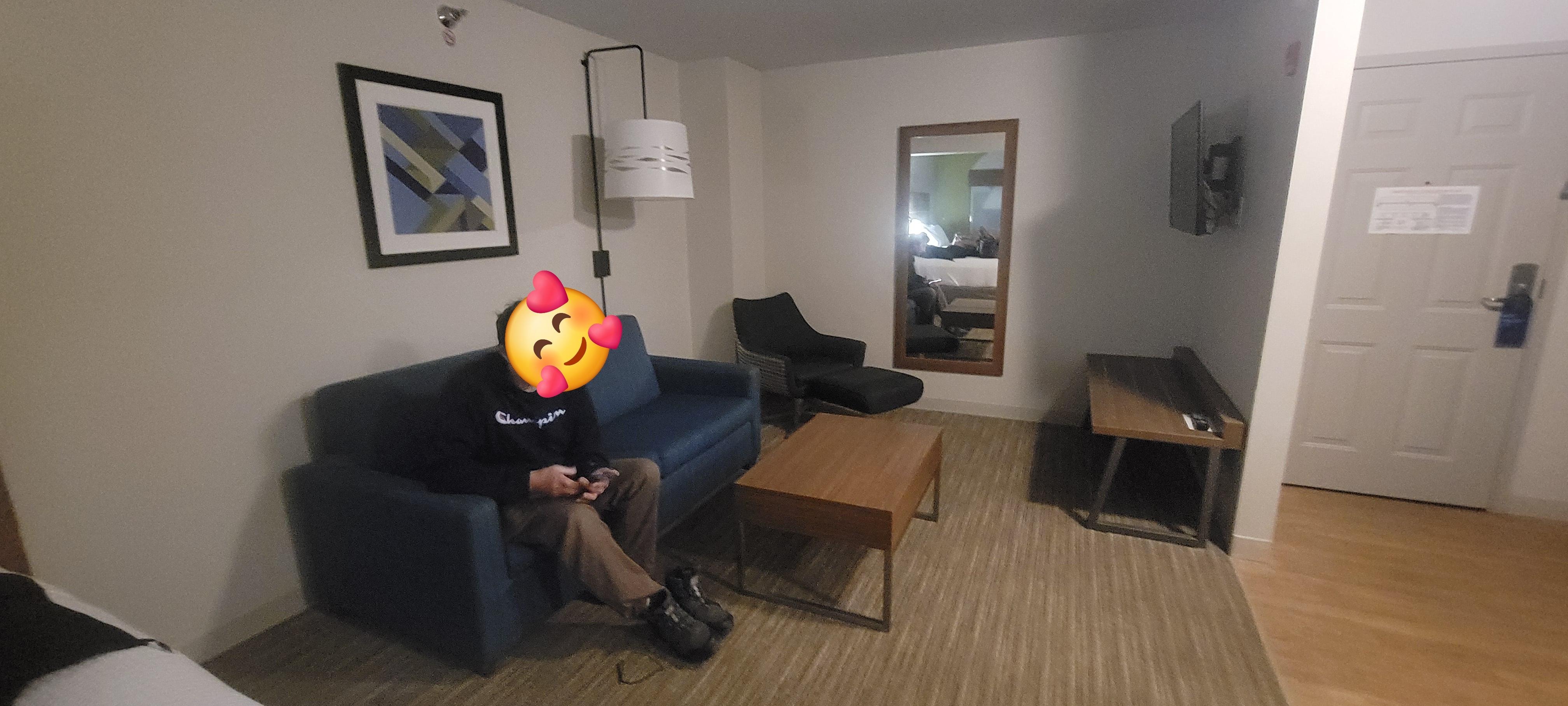 The sitting area that had a table that pulls up to your level and a tv.