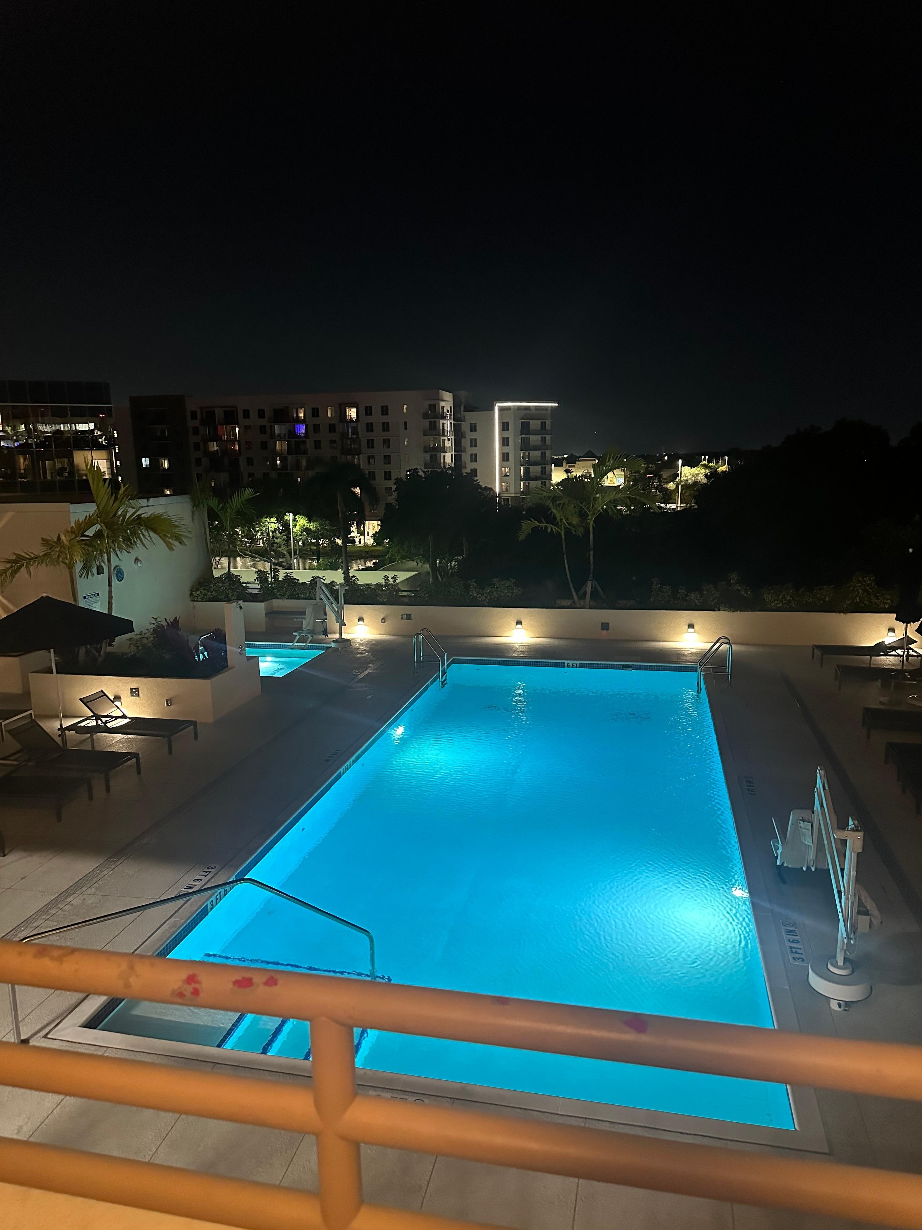 Night time view of the Pool and hot tub area. nice but furniture was stained and dirty