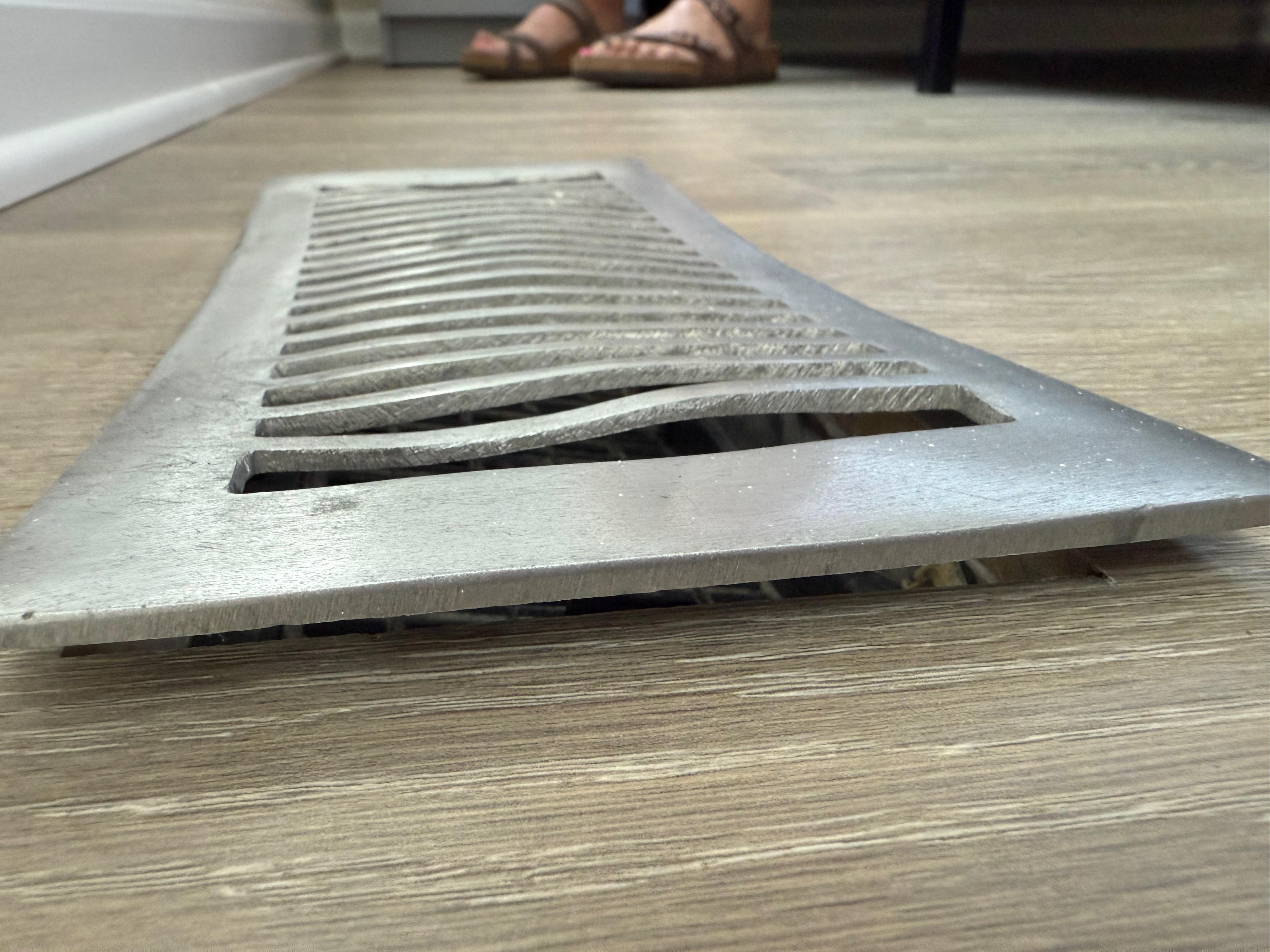 Twisted heat register that didn't fit closely to the floor.