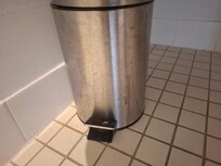 The rubish bin inside the toilet very old and dirty