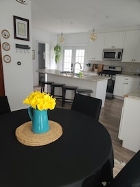 The kitchen is spacious with plenty of counter space to prep, cook, serve, and gather.
