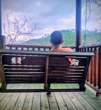 My autistic son enjoying the swing and the mountains