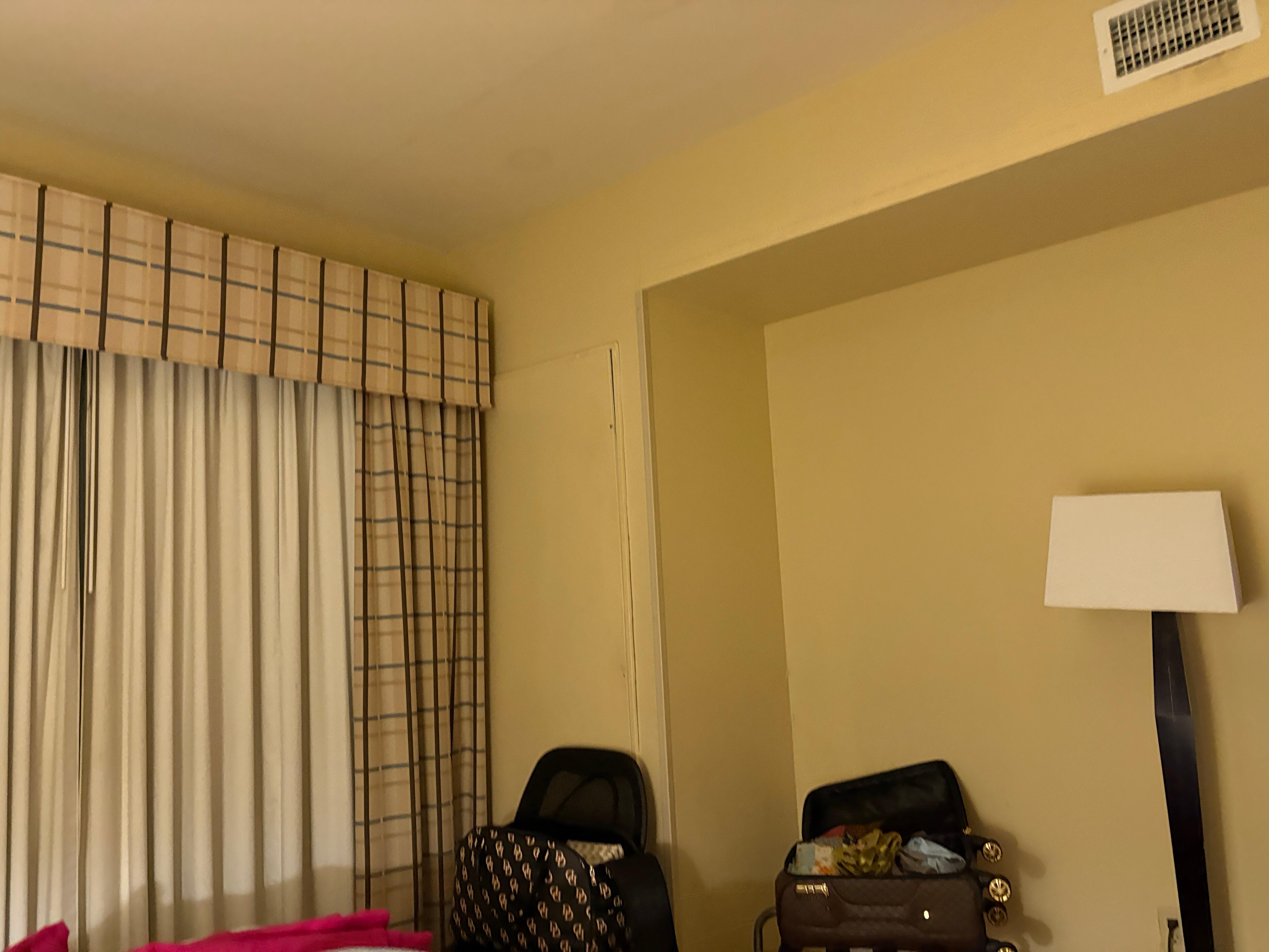 Air conditioner panel propped up against the walk, noting the brackets were bent and broken, producing mold and condensation. 