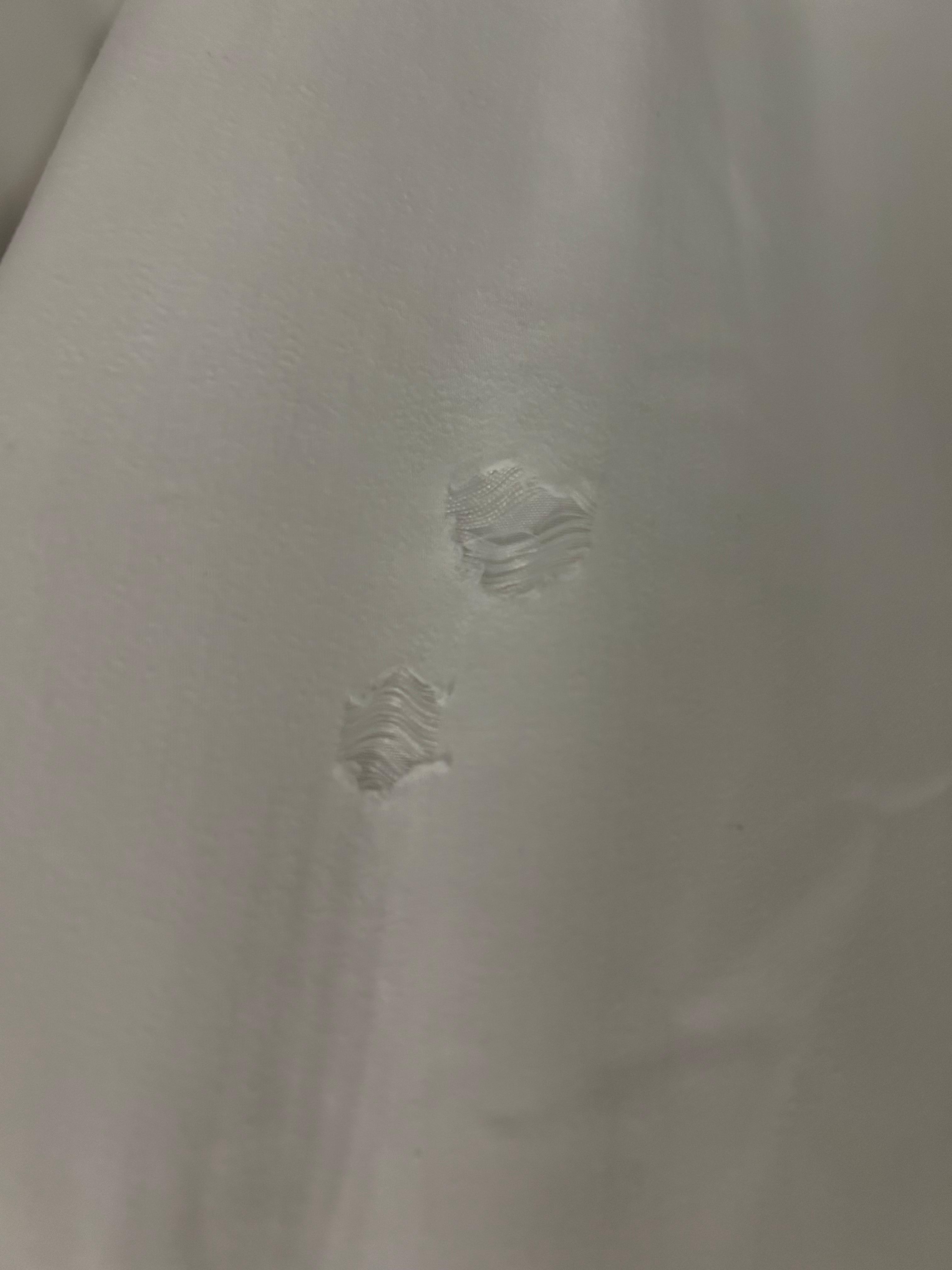 Ripped sheet on bed
