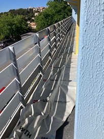 Walkway outside our room - note blown floor cover and partially painted fence